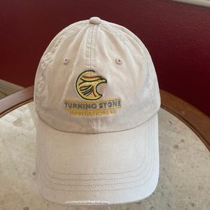 Turning stone, invitational, beige baseball cap.
